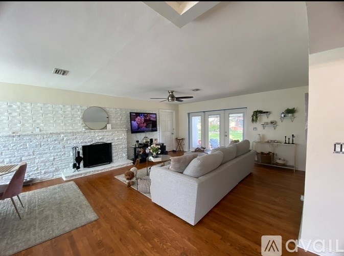 A living room with a fireplace and a television.