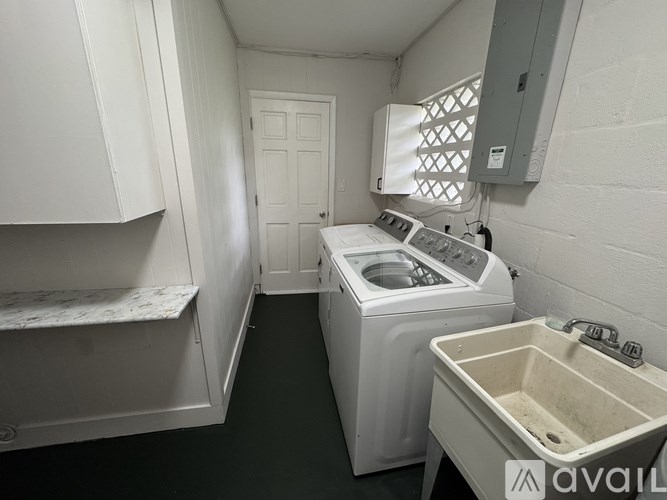 A small laundry room with a washer and dryer.