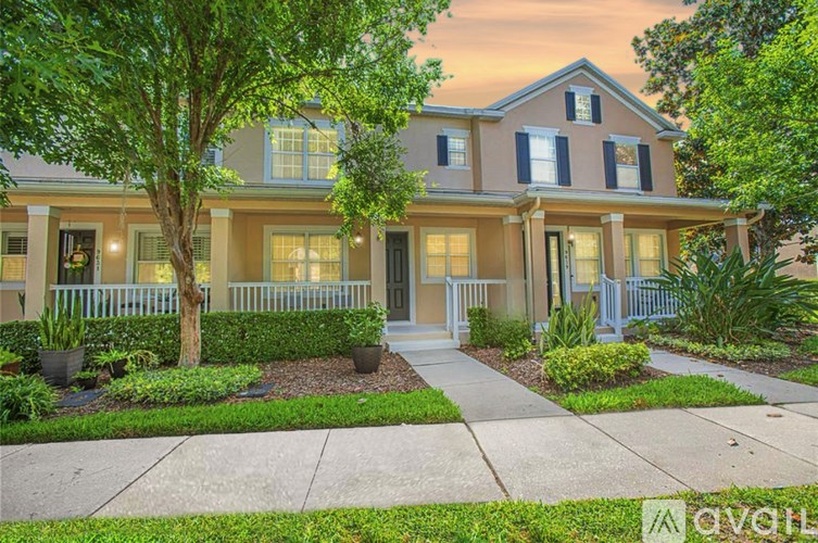 A house with a front yard and a tree.