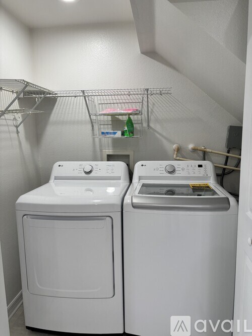 Two front loading washing machines in a laundry room.