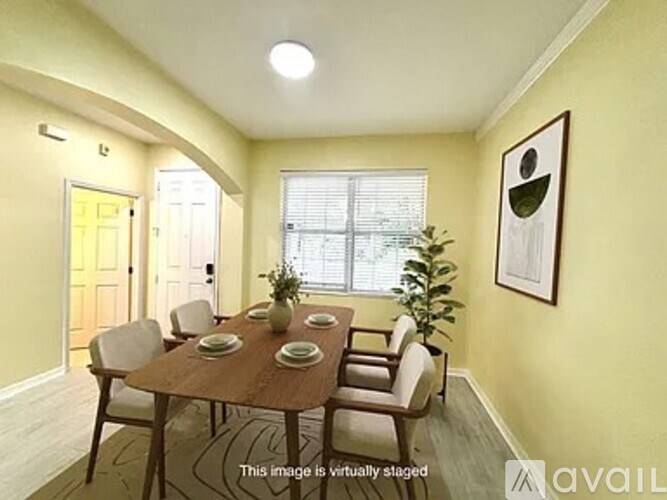 A dining room with a wooden table and chairs.