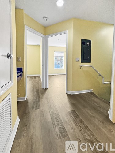 A hallway with a white door and a white radiator.