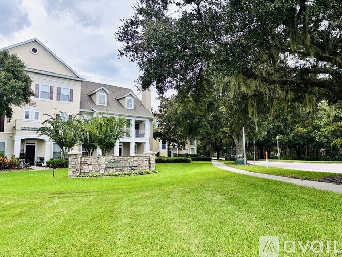 A large house with a stone wall in front of it.