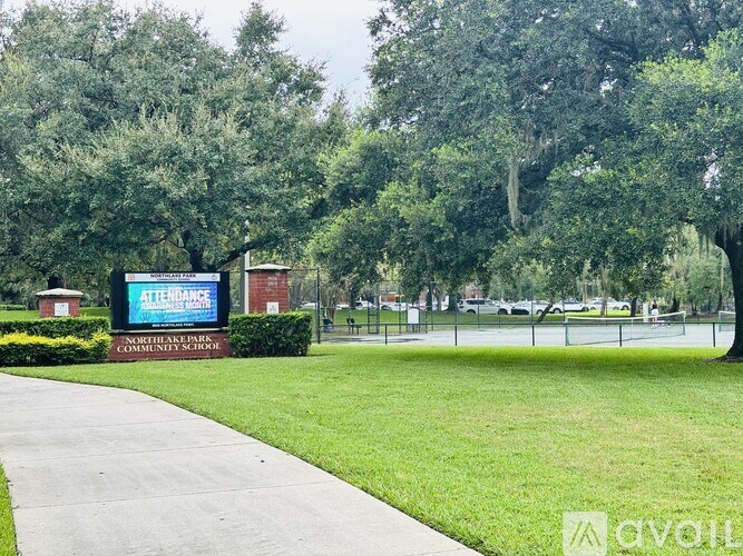 A sign for Northlake Community School is displayed in front of a grassy area.