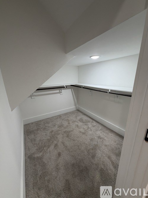 A room with a carpeted floor and white walls.