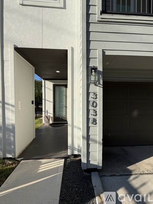 A white house with the number 938 on the garage door.