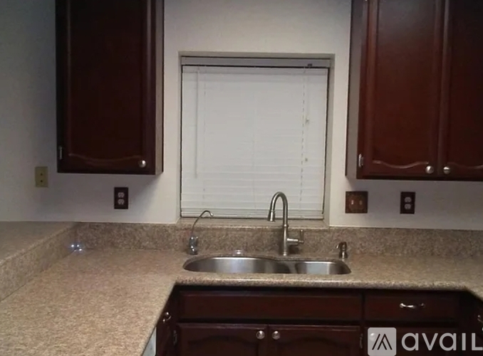 A small, clean kitchen with a dishwasher and a washing machine.