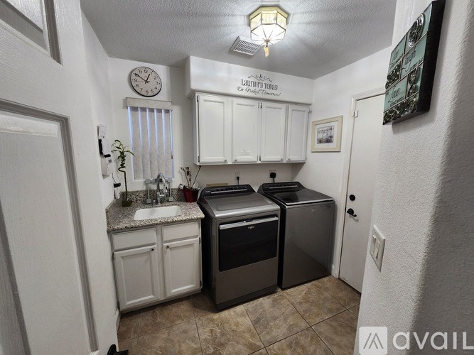 A small, clean kitchen with a dishwasher and a washing machine.