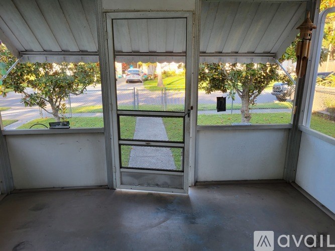 A view from inside a house looking out through a door to a street.