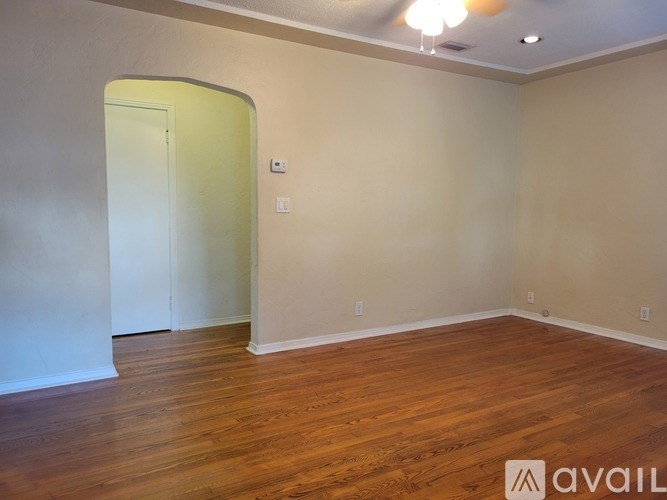 A room with wooden flooring and a white door.