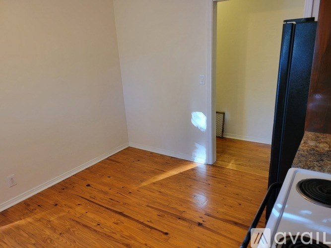 A room with wooden floors and white walls.