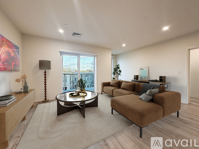 A spacious kitchen with wooden floors and a large island in the middle.