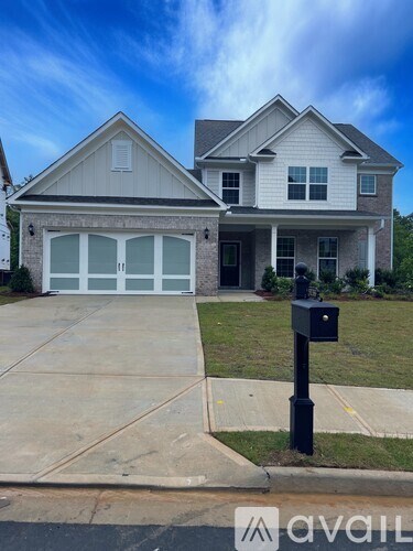A two-story house with a garage is shown in the image.