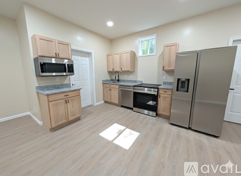 A kitchen with wooden cabinets and stainless steel appliances.