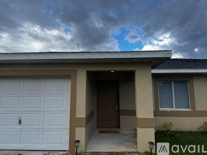 A house with a garage door and a brown door is available for sale.