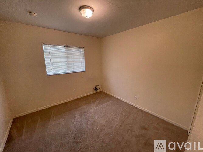 A room with a window and a ceiling light.