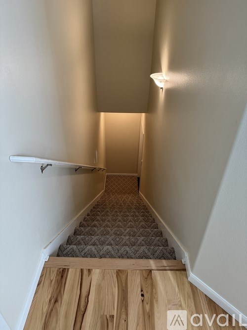 A stairway with a light on the wall.