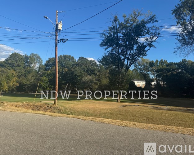 A street view with a sign for NDW PROPERTIES.