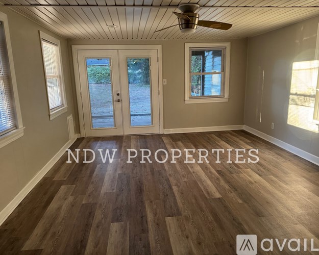 A room with a ceiling fan and wooden flooring is on the market with NDW Properties.
