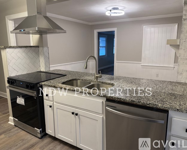 A kitchen with granite countertops and stainless steel appliances.