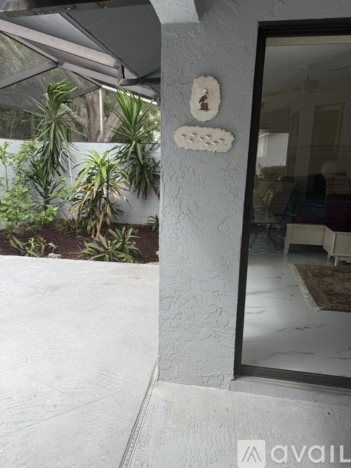 A white wall with three decorative holes in it.