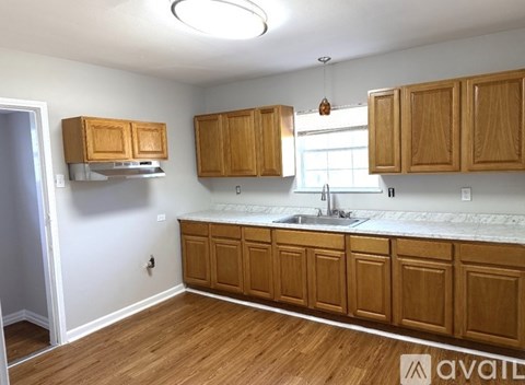 A kitchen with wooden cabinets and a white countertop.