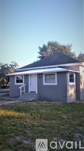A small house with a porch is for sale.
