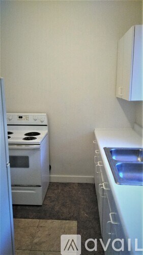 A small kitchen with a stove and a refrigerator.