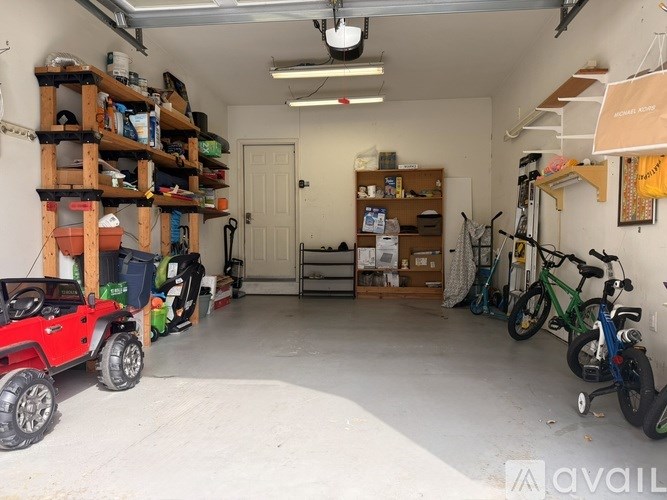 A garage with a red vehicle on the left and a bicycle on the right.