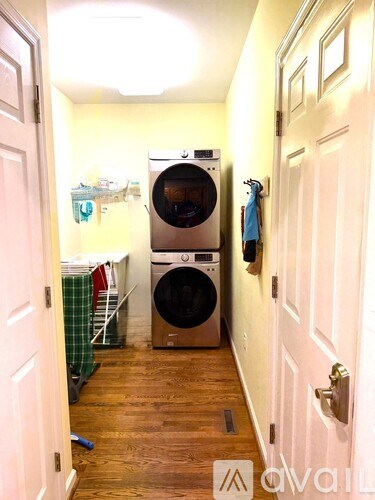 A small laundry room with a washer and dryer.