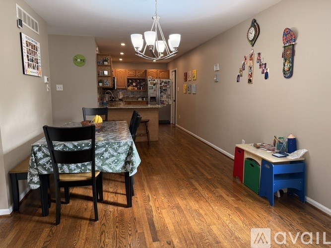 A dining room with a table and chairs.