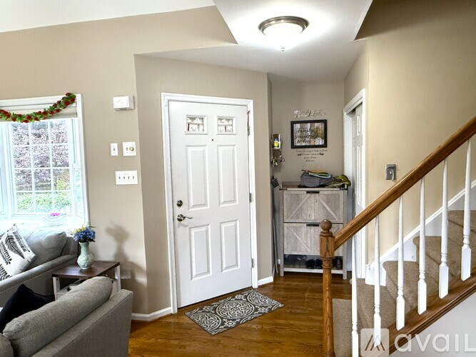 A living room with a grey couch and a white door.