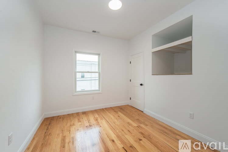 A room with wooden floors and a window.