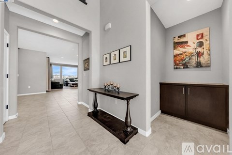 A living room with a table and chairs in the center.