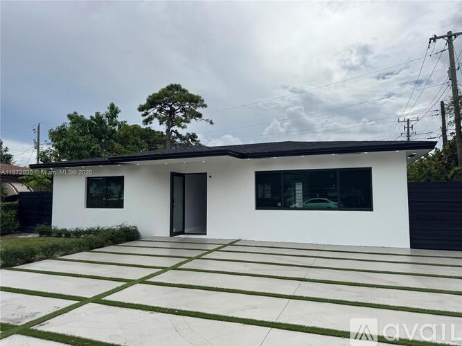 A modern white house with a black roof and a glass door.