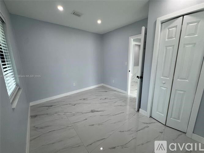 A room with marble flooring and white walls.