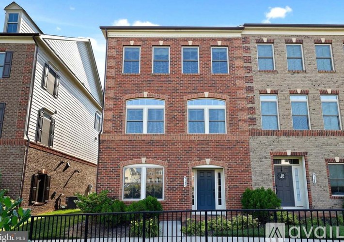A row of houses with a sign that says "available" in front of them.