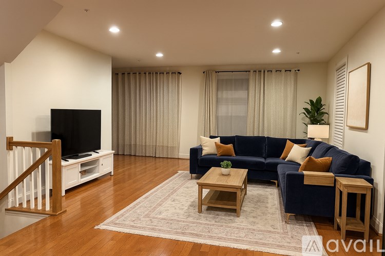 A living room with a blue couch and a television.
