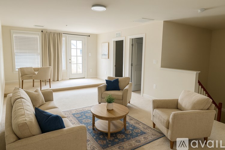 A living room with beige furniture and a blue rug.