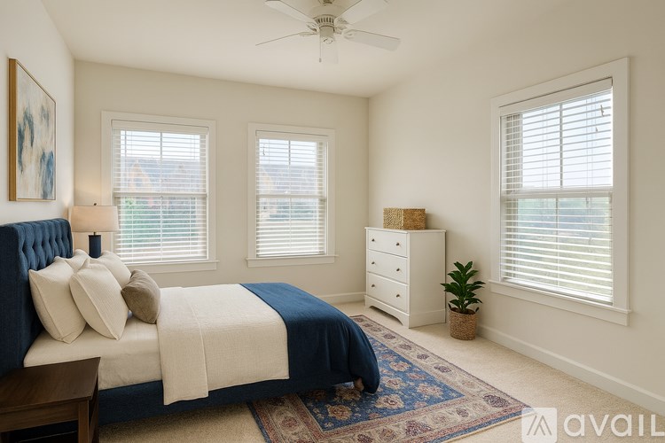A bedroom with a bed, dresser, and window with blinds.