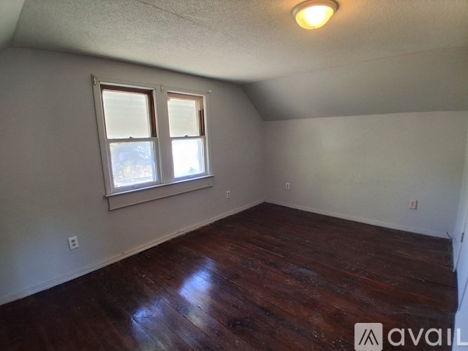 A room with wooden floors and a window.