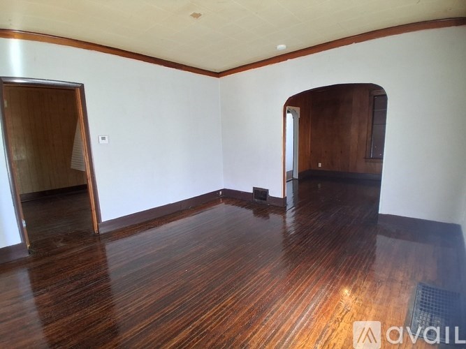 A room with wooden floors and white walls.