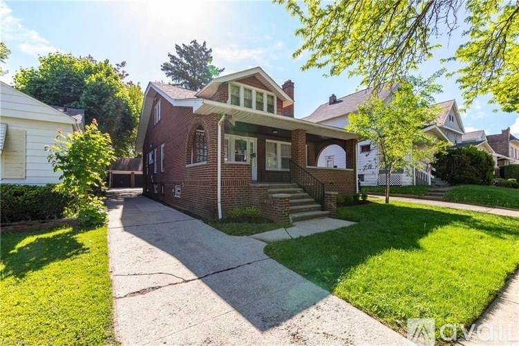 A house with a brick facade and a white porch.