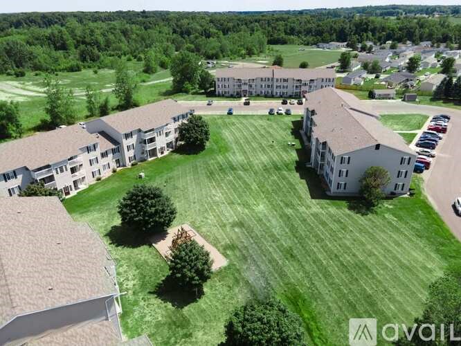 A bird's eye view of a large grassy area surrounded by buildings.