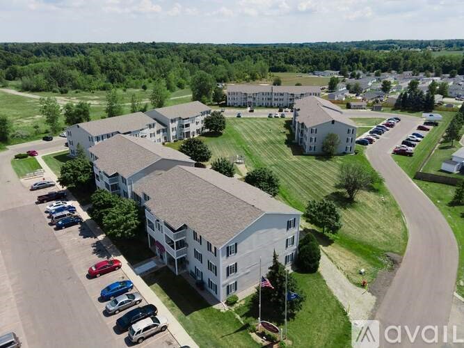 A large building with a parking lot in front of it.