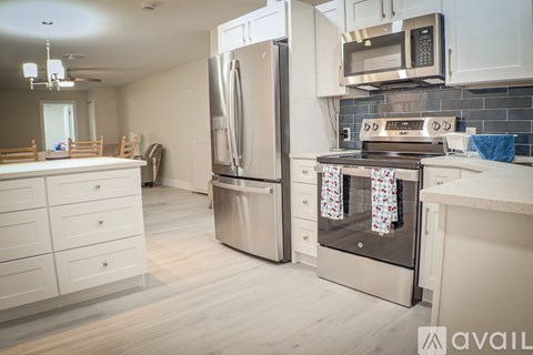 A kitchen with a stainless steel refrigerator and oven.