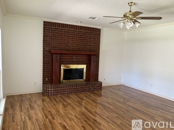 A room with a fireplace and a ceiling fan.