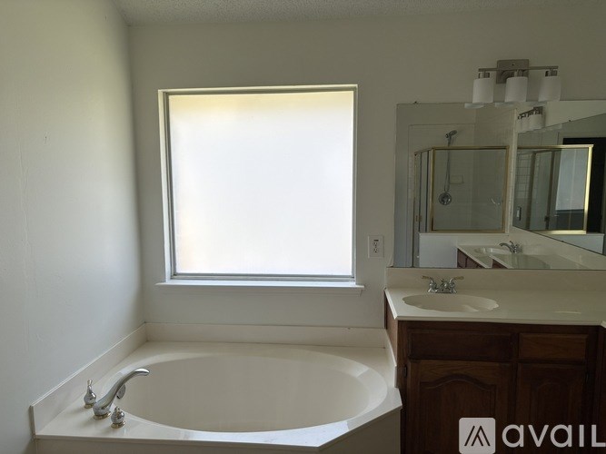 A bathroom with a white tub and sink.