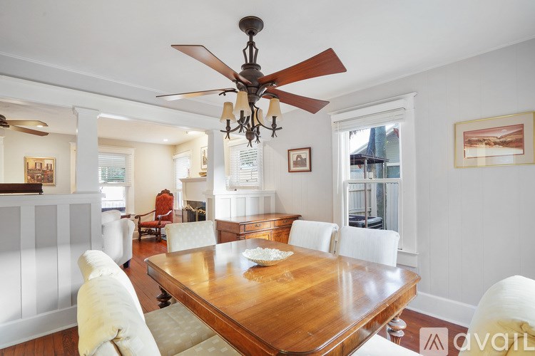 A dining room with a wooden table and chairs.