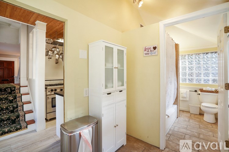 A kitchen with a white cabinet and a sign on the wall that says "Love you".